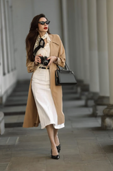 a lady in a white shirt, a white skirt and a brown trench coat